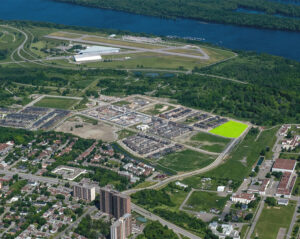 Bird's-eye view of the airport and adjacent region, showcasing Wateridge Village and its surroundings.