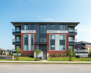 Large apartment building in Wateridge Village with an expansive parking lot in front.